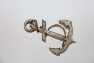 A large Victorian white metal brooch in the form o
