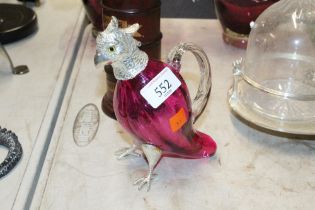 A silver plated and cranberry glass claret jug