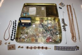 A tin of various costume jewellery including Trifa