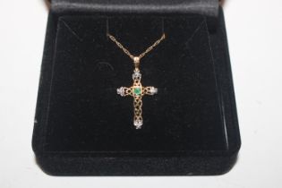 A 9ct gold crucifix pendant set with coloured ston
