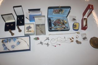 A box of various costume jewellery including brooc