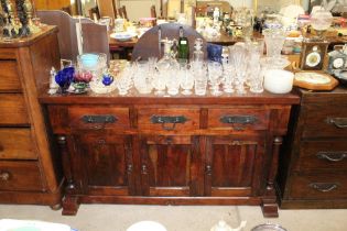 A hardwood sideboard fitted three drawers and cupboard below