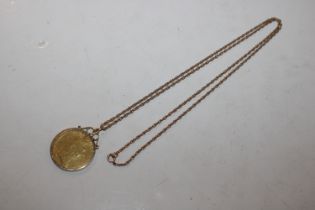 A Guinea contained in 9ct gold mount and hung to y