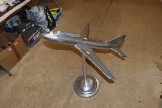 A chrome floor standing model of a jet aircraft