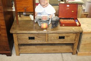 An oak coffee table fitted two drawers