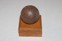 A canon ball on a wooden stand