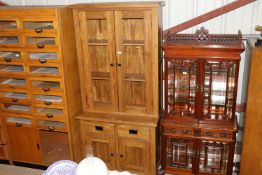 A modern light oak display cabinet fitted two draw
