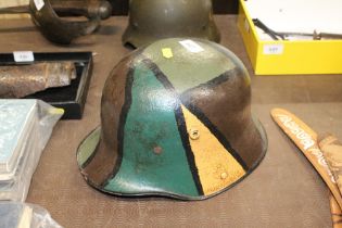 A German WWI 1916 pattern helmet with camo paint f