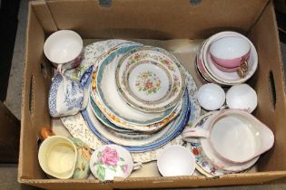 A box containing various tea and dinnerware