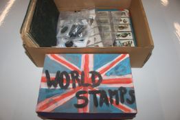 A box containing various world stamps; a stamp alb