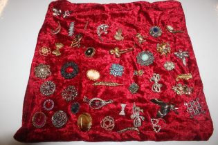 A collection of decorative costume brooches