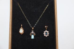 A 9ct gold opal pendant; similar blue topaz and di