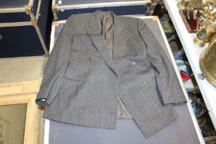 A box containing a suit and two suit jackets