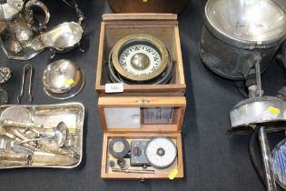 A ships compass and a cased meter