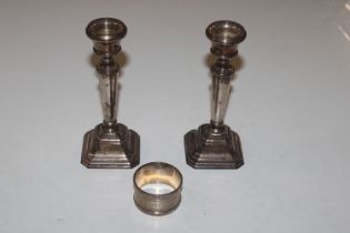 A pair of silver candle sticks with filled bases