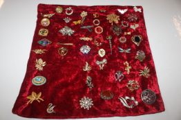 A collection of decorative costume brooches