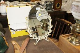 A bevel edged oval easel mirror