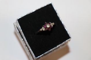 A yellow metal garnet and diamanté set ring