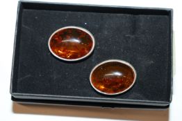 A pair of large sterling silver and amber clip ear