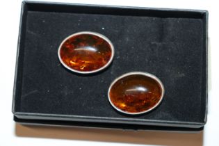 A pair of large sterling silver and amber clip ear