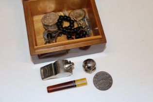 A burr wood trinket box and contents to include a whistle; coins; cuff-links etc