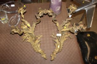 A pair of gilt Rococo style triple branch wall lig