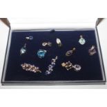 Eleven 9ct gold pendants set with coloured stones