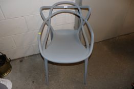 A grey Kartell Masters designed by Starck elbow cha