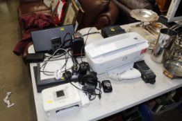 A Hewlett Packard printer, a Bose docking system a