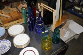 A collection of various coloured glassware