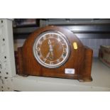 An oak cased chiming mantel clock