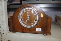 An oak cased chiming mantel clock