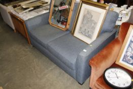 A charcoal upholstered two seater sofa bed
