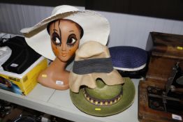 A collection of ladies hats and a mannequin head