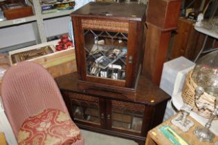 An oak corner television cabinet; an oak Hi-fi cab