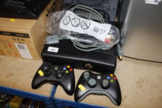 An X-Box 360 with controllers lacking power lead