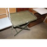 A wicker tray top side table on folding stand