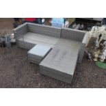 A rattan style L shaped garden settee lacking cush