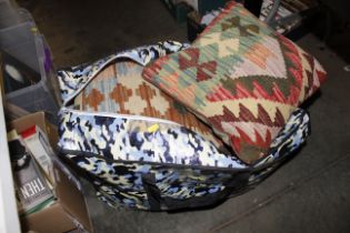 A bag containing various Kelim cushions etc.