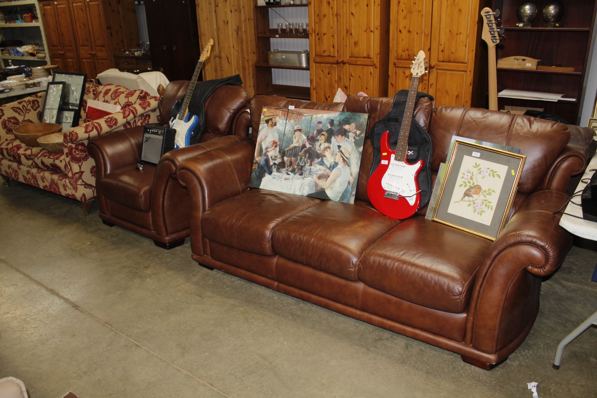 A leather three seater settee and matching armchair