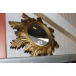 A circular Florentine style gilt wall mirror