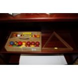 A set of pool balls and triangle etc in wooden car