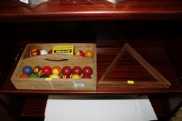 A set of pool balls and triangle etc in wooden car