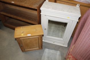 A pine wall cupboard and a painted mirrored bathro