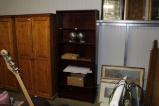 A teak effect open fronted bookcase