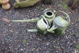 Three various galvanised watering cans