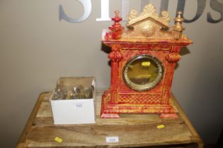 A mantel clock in decorative case, brackets and mo