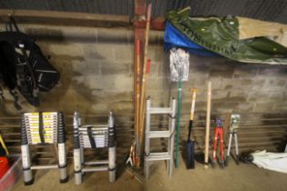 A quantity of WolfGarten long handled tools and a quantity of WolfGarten tool head attachments