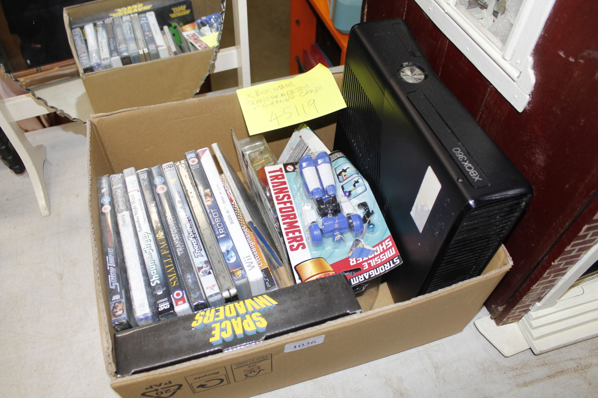 A box of various games; Transformer toys; gaming c