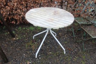 A plastic circular garden table on metal base